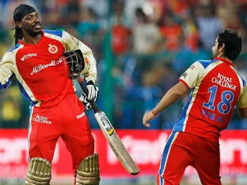 Chris Gayle celebrating his century for RCB as a replacement player in IPL 2011