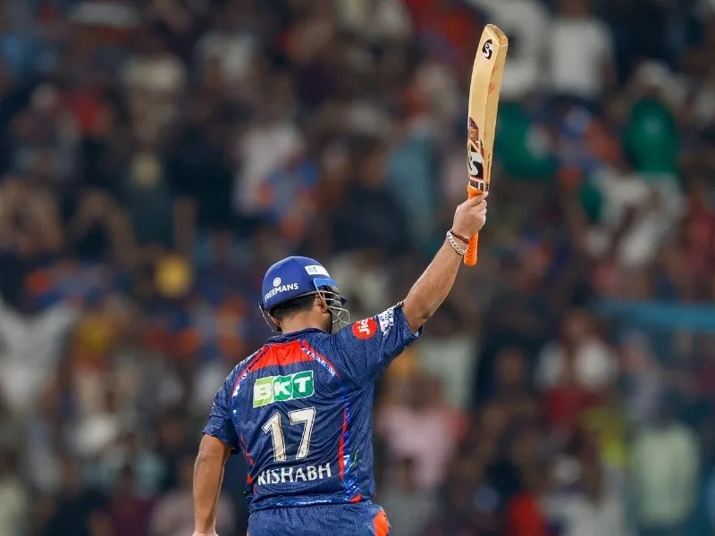 Rishabh Pant raises his bat after scoring a 54-ball century for LSG in IPL 2025 against RCB.