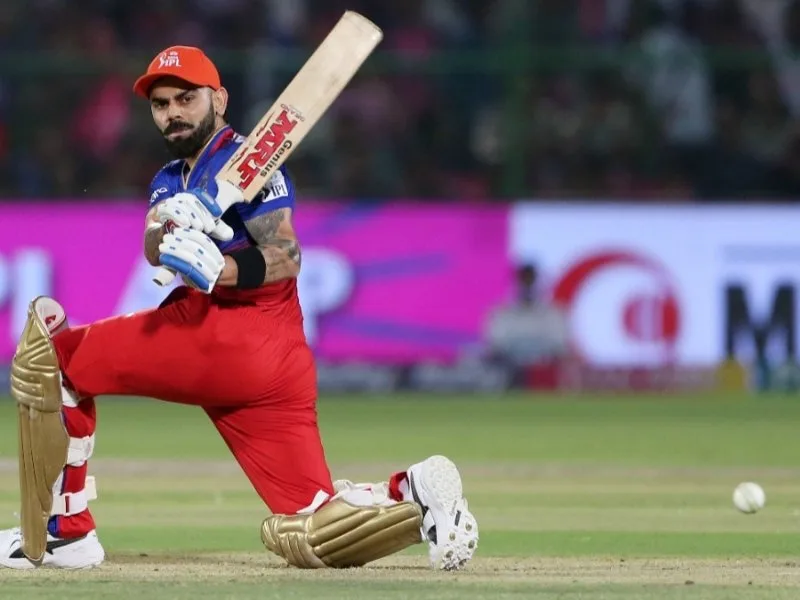 Virat Kohli batting for RCB amidst strike rate controversy in IPL 2025 match.
