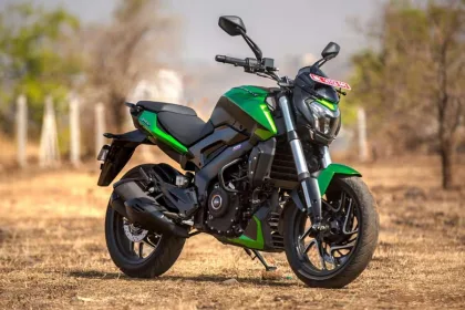 Bajaj Dominar 400 in Charcoal Black parked on highway with LED headlamps and muscular tank