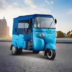 Bajaj GoGo P5009 in Ocean Blue parked on city street with LED headlights and rugged steel body