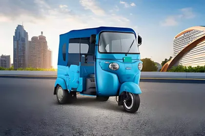 Bajaj GoGo P5009 in Ocean Blue parked on city street with LED headlights and rugged steel body
