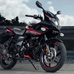 Bajaj Pulsar 220 F in Volcanic Red parked on city street with dual projector headlamps and semi-fairing