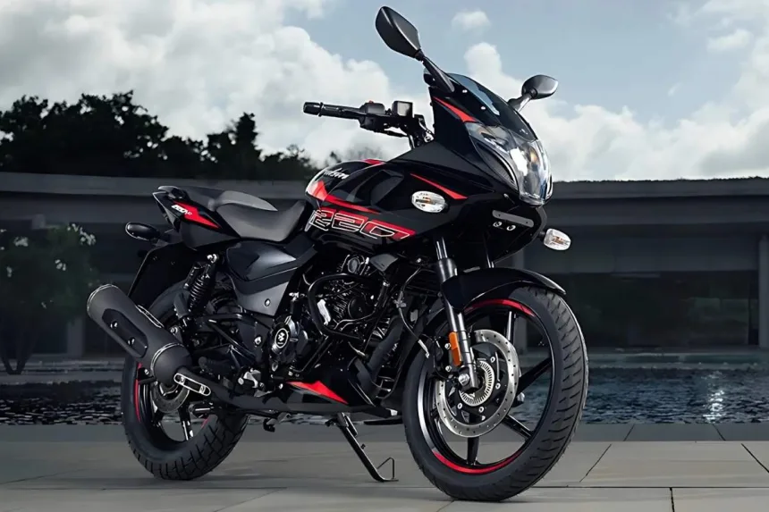 Bajaj Pulsar 220 F in Volcanic Red parked on city street with dual projector headlamps and semi-fairing