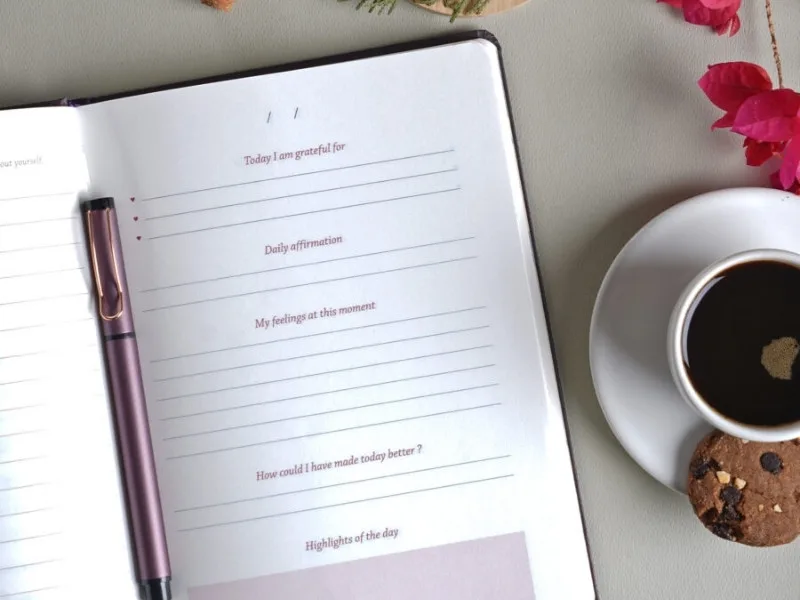 Person writing in gratitude journal during morning ritual, 2025