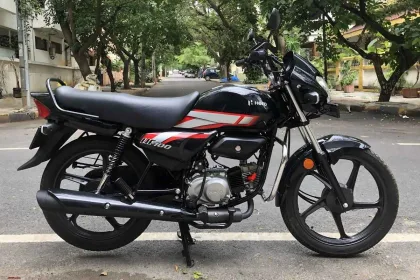Hero HF 100 2025 in Black with Red graphics, showcasing budget-friendly commuter bike design for Telugu riders