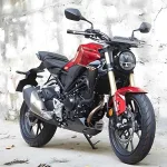 Honda CB300R in Pearl Spartan Red parked on city street with neo-retro round LED headlamp