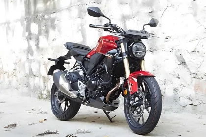 Honda CB300R in Pearl Spartan Red parked on city street with neo-retro round LED headlamp