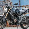 Honda CB650R in Matt Gunpowder Black Metallic parked on city street with neo-retro LED headlamp