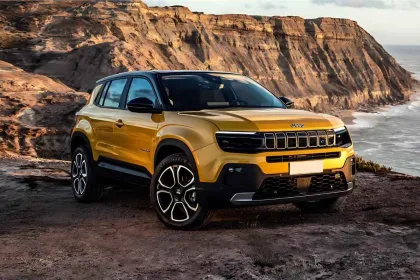 Jeep Avenger 2026 in Sun Yellow parked in city with LED headlights, showcasing stylish electric SUV design