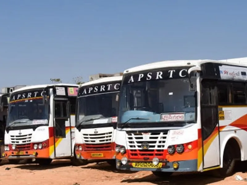 Devotees at Triveni Sangamam during Saraswati Pushkaralu 2025 with APSRTC buses in the background