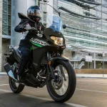 2025 Kawasaki Versys-X 300 in Blue-White color parked on rugged terrain with halogen headlights and adventure-ready design