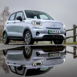 Leapmotor T03 in Blue parked on city street with rounded Fiat 500-inspired LED headlamps