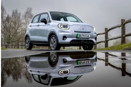 Leapmotor T03 in Blue parked on city street with rounded Fiat 500-inspired LED headlamps