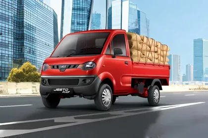 Mahindra Jeeto in Blue parked on city street with spacious cargo body and halogen headlights
