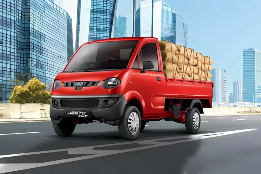 Mahindra Jeeto in Blue parked on city street with spacious cargo body and halogen headlights