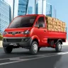 Mahindra Jeeto in Blue parked on city street with spacious cargo body and halogen headlights