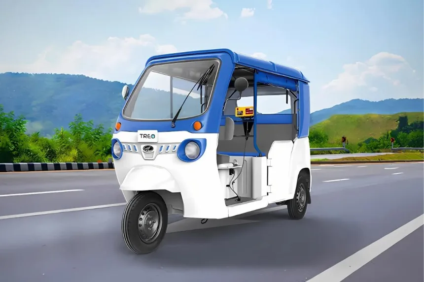 Mahindra Treo Limited Edition in Blue-Green parked on city street with LED headlights and spacious cabin