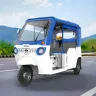 Mahindra Treo Limited Edition in Blue-Green parked on city street with LED headlights and spacious cabin