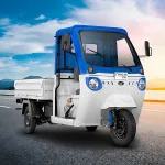 Mahindra Treo Zor in Green parked on city street with LED headlights and spacious cargo body