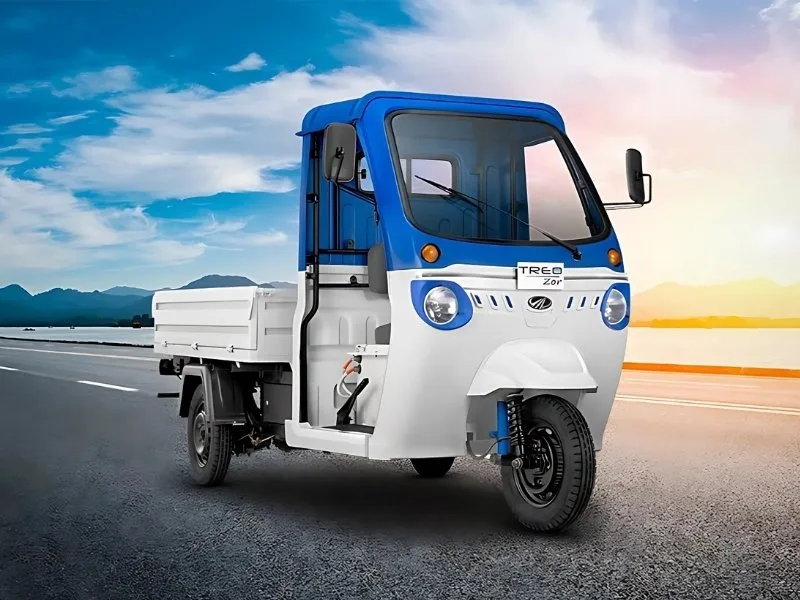 Mahindra Treo Zor in Green parked on city street with LED headlights and spacious cargo body