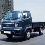 Mahindra Veero in Silver parked on city street with LED DRLs and spacious cargo body