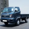 Mahindra Veero in Silver parked on city street with LED DRLs and spacious cargo body