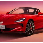 MG Cyberster 2025 in Dynamic Red with scissor doors open, showcasing futuristic electric sports car design