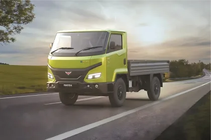 Montra Electric Eviator 2025 in green parked in city with cargo deck, ideal for eco-friendly logistics