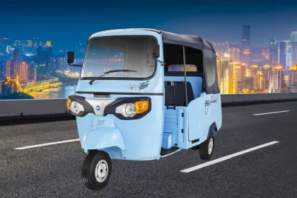 Piaggio Ape E-City in Green parked on city street with LED headlights and 3-seater cabin
