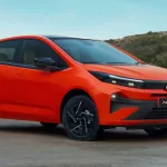 2025 Tata Altroz Facelift in Dune Glow parked on city street with LED headlights and flush door handles