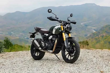 Triumph Scrambler 400 X 2025 in Carnival Red parked on gravel, showcasing neo-retro scrambler design for Telugu riders