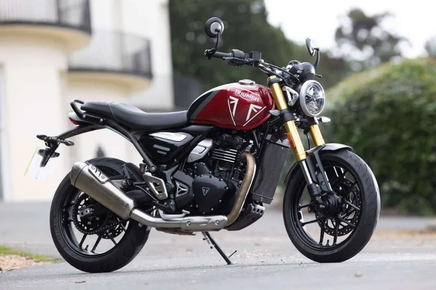 Triumph Speed 400 2025 in Carnival Red parked in city, showcasing neo-retro roadster design for Telugu riders