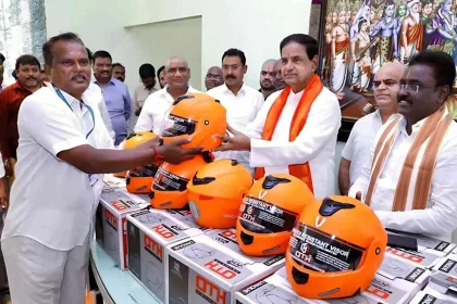 TTD employees receiving free ISI helmets from BR Naidu during a road safety event in Chittoor