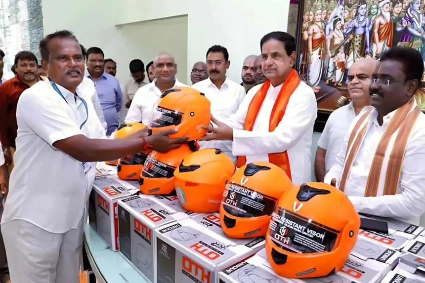 TTD employees receiving free ISI helmets from BR Naidu during a road safety event in Chittoor