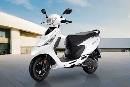 TVS Scooty Zest in Matte Blue color parked on city street with LED taillight
