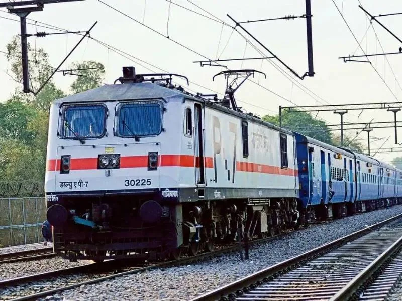 Passengers checking waiting ticket status at a railway station in 2025
