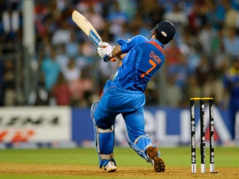 MS Dhoni hitting the iconic six in the 2011 World Cup final at Wankhede Stadium, celebrated in 2025.