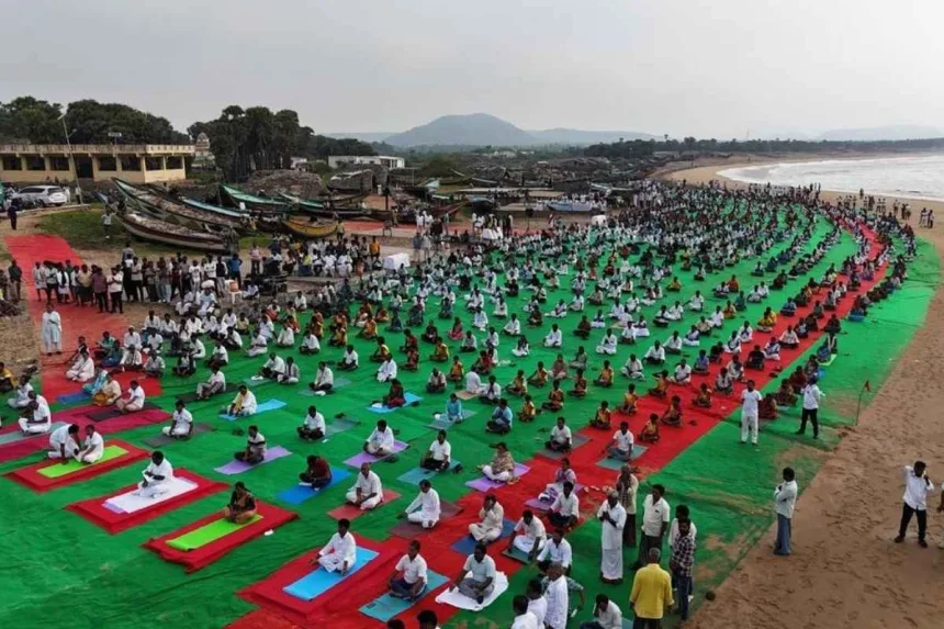 Hundreds practicing yoga at Chintapalli Beach in Vizianagaram during Yogandhra 2025