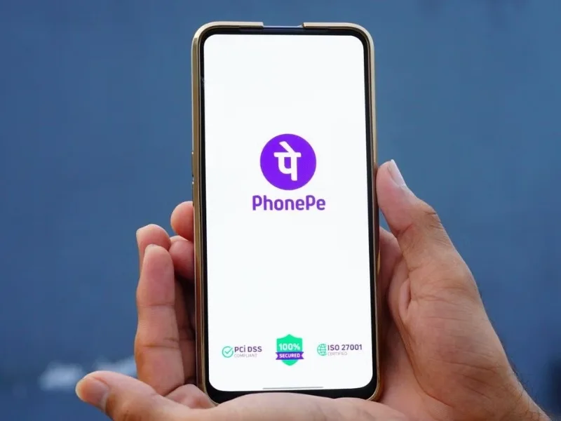 Feature phone displaying PhonePe UPI payment app for digital transactions in India.
