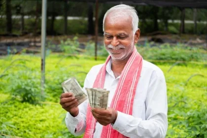 Farmer checking PM-KISAN 20th installment status on smartphone, expected to be credited on June 20, 2025.