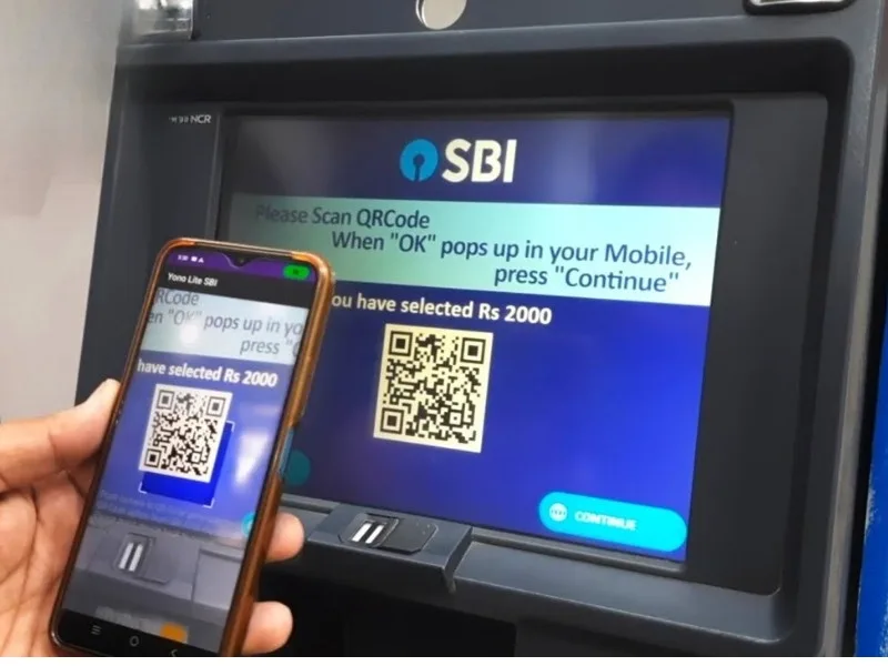 Smartphone scanning QR code at SBI ATM for cardless cash withdrawal using UPI app, introduced in 2025.