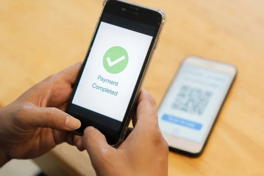 Smartphone displaying UPI transaction on PhonePe, Google Pay, or Paytm, highlighting faster processing starting June 16, 2025.