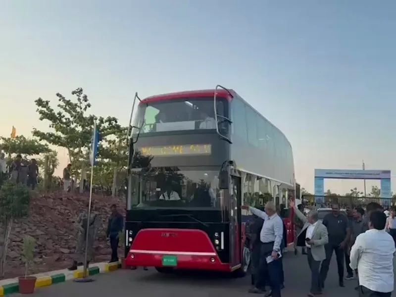 Tourists enjoying Vizag’s RK Beach and Rushikonda from a 2025 double decker bus tour.